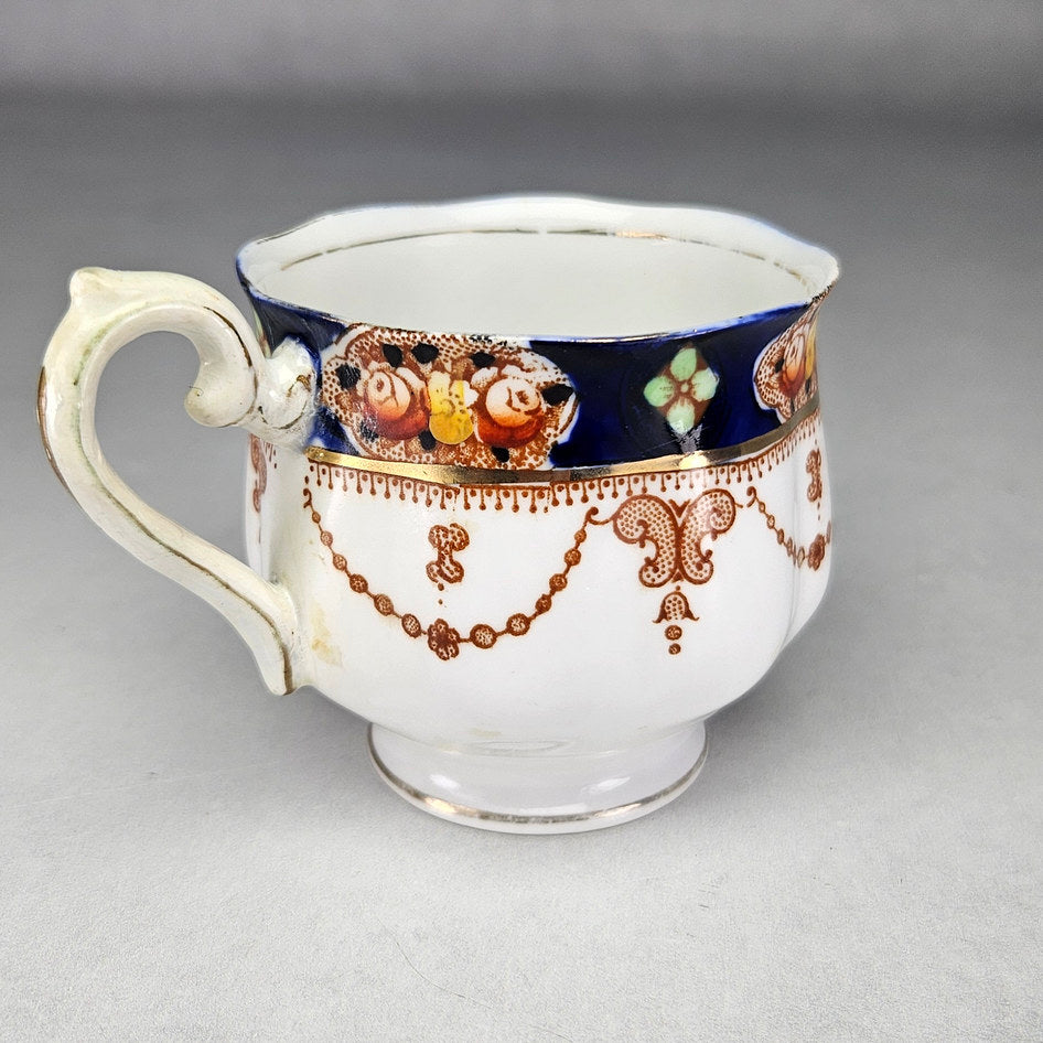 Royal Albert cup showing floral cartouches and gilding