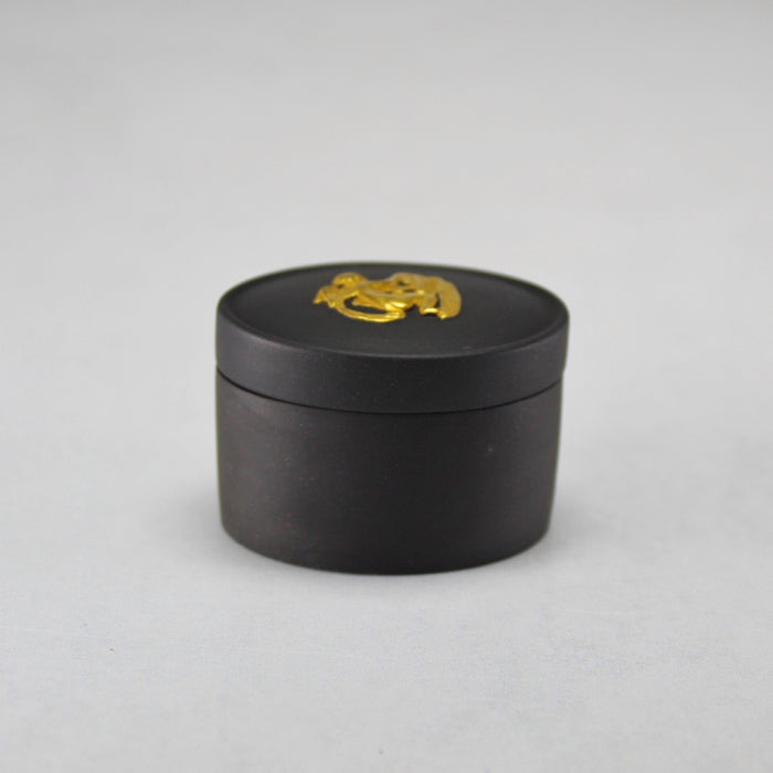 Wedgwood Gold on Black Jasperware Lidded Pill Box with Cherub Relief Figure, view 1